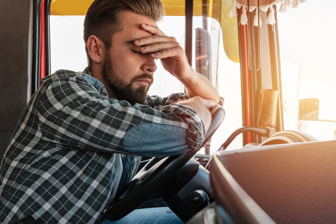Trucker who is not feeling well due to unhealthy habits during the cold and flu seasons.