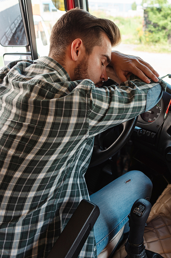 Trucker who is not feeling well due to unhealthy habits during the cold and flu seasons.