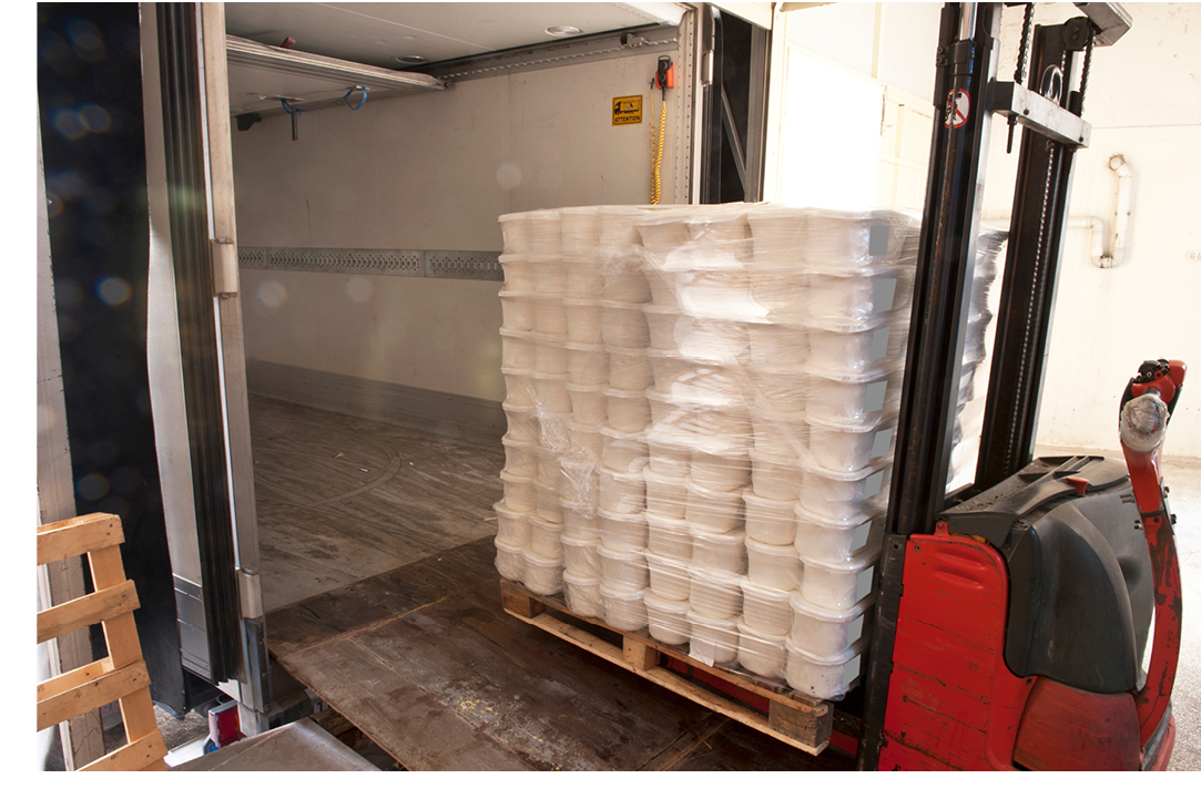 Semi truck trailer being loaded with freight by a forklift