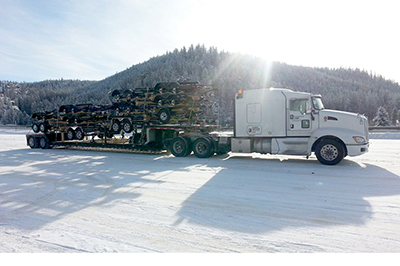 Buchanan Hauling step deck flatbed transporting automotive parts.