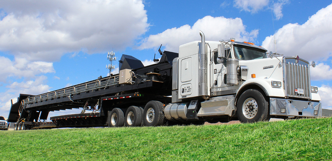 Buchanan Logistics transporting an elevator or conveyor system for a facility using their step deck trailer.